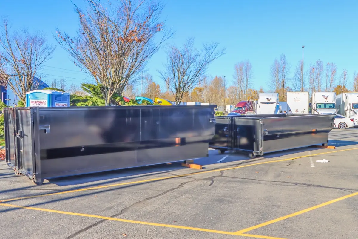 Professional dumpster rental service with roll-off container on residential driveway in Briar